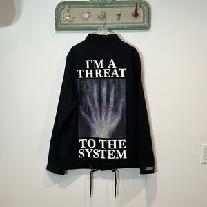PLEASURES IM A THREAT TO THE SYSTEM X-RAY COACHES JACKET SIZE LARGE NWOT BLACK